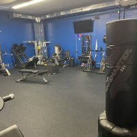 Strength-training equipment in the fitness room, available to bunk-in members during their stay.