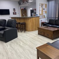 The day room, with recliners and a bar counter where members gather off duty.