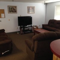 A comfortable lounge with sofas and a TV for relaxing off duty.