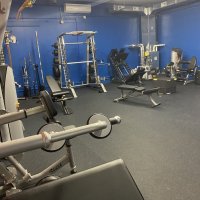 Free weights and a squat rack in the station fitness room.